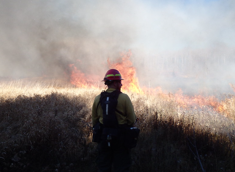Firefighters working on a fire with heavy smoke presence