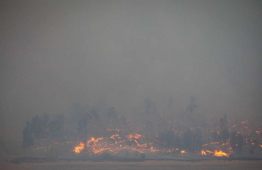 Firefighters working on a fire with extreme smoke presence