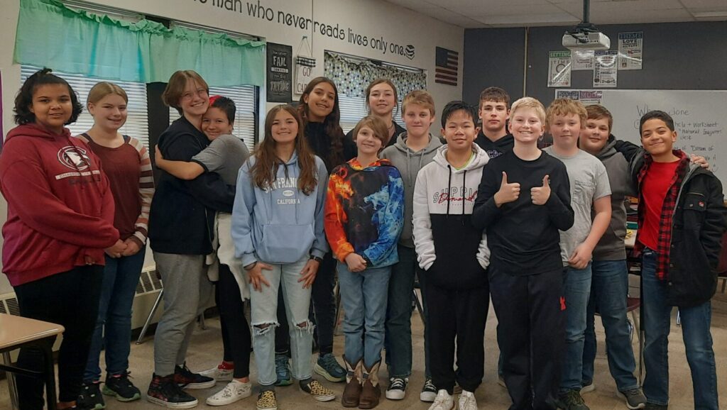Mrs. Waugh's 7th and 8th grade class standing in a classroom at Chadron Middle School.
