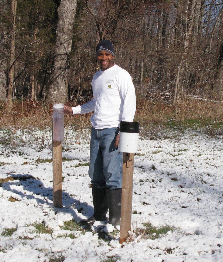 Mr. Johnny Boggs standing between two posts in the snow
