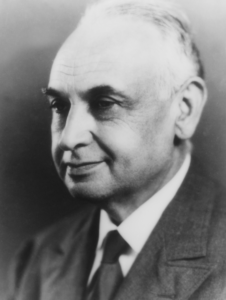 A black and white portrait of Edward Kotok