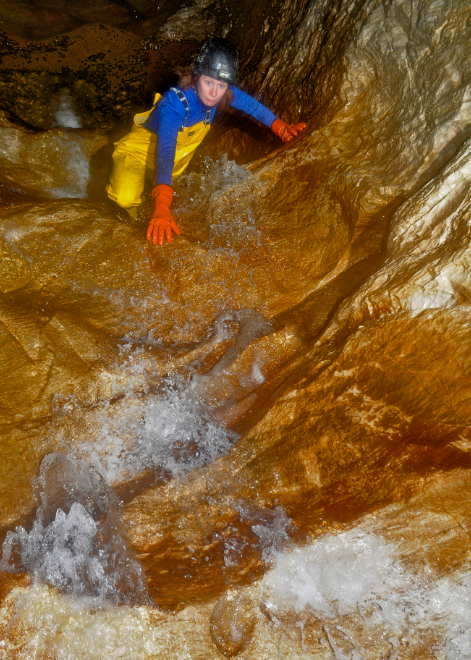 Joanna Kovarik climbs in a cave.