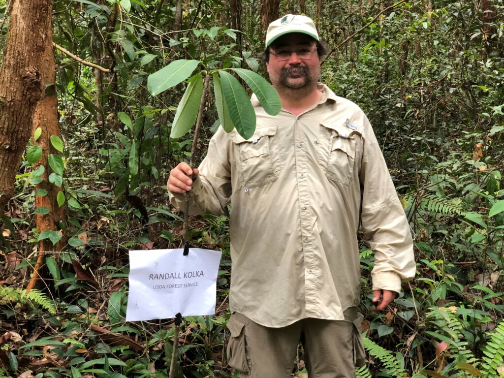 Randy Kolka holding up a plant