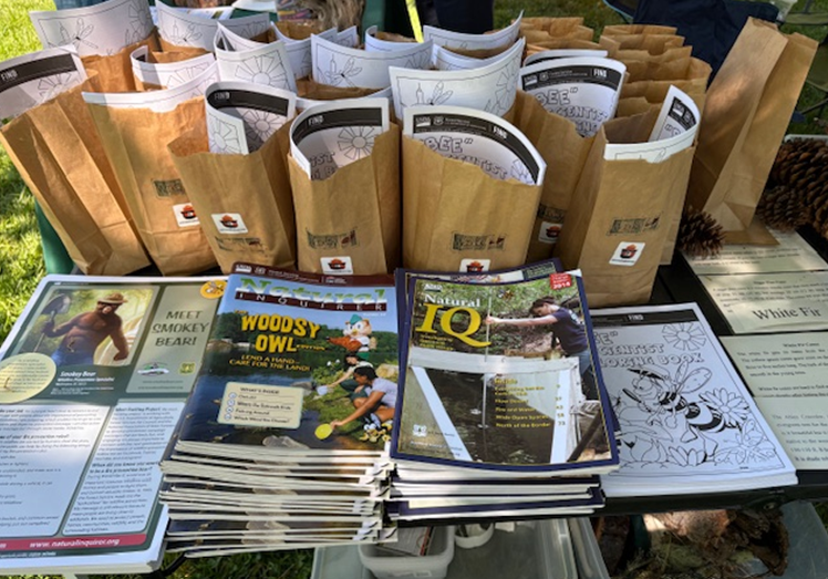 Natural Inquirer materials set up at a booth outside for an event