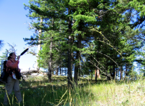 Aubree holding up a recording device outside