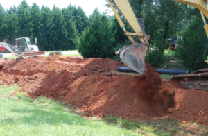 Pipes being laid in the ground with the use of heavy machinery 