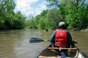 A person on a canoe in a river