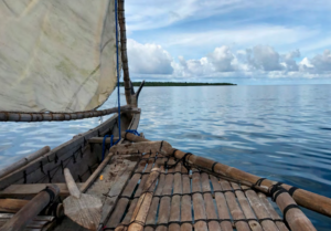 A view of the ocean from on board a Yapese canoe made of wood.