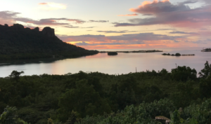 An island coastline in silhouette at sunset