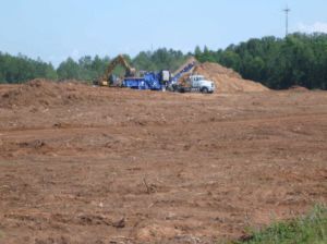 Excavator clearing a large plot of land