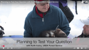 Thumbnail from the Planning to Test Your Question with Keith Aubry YouTube Video featuring Aubry holding a wolverine 