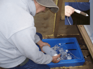 A scientist preparing a vacuum pump