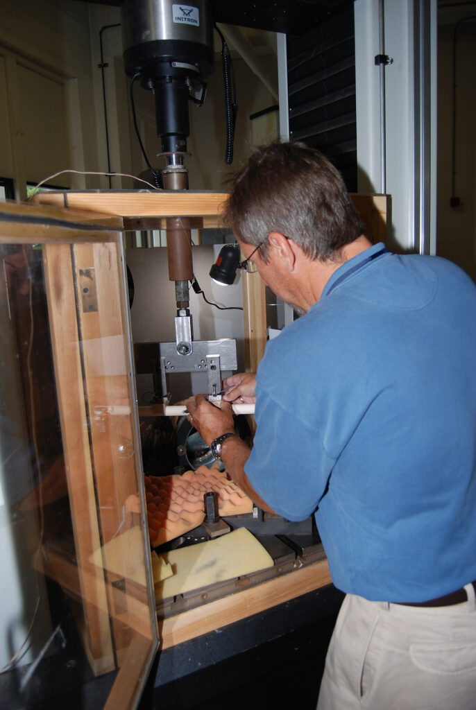 Engineer placing a dowel in the testing chamber