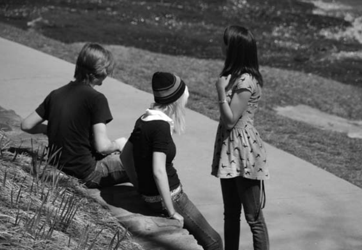 Three kids hanging out together outside
