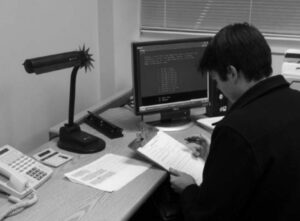 A person conducting a phone interview at a desk