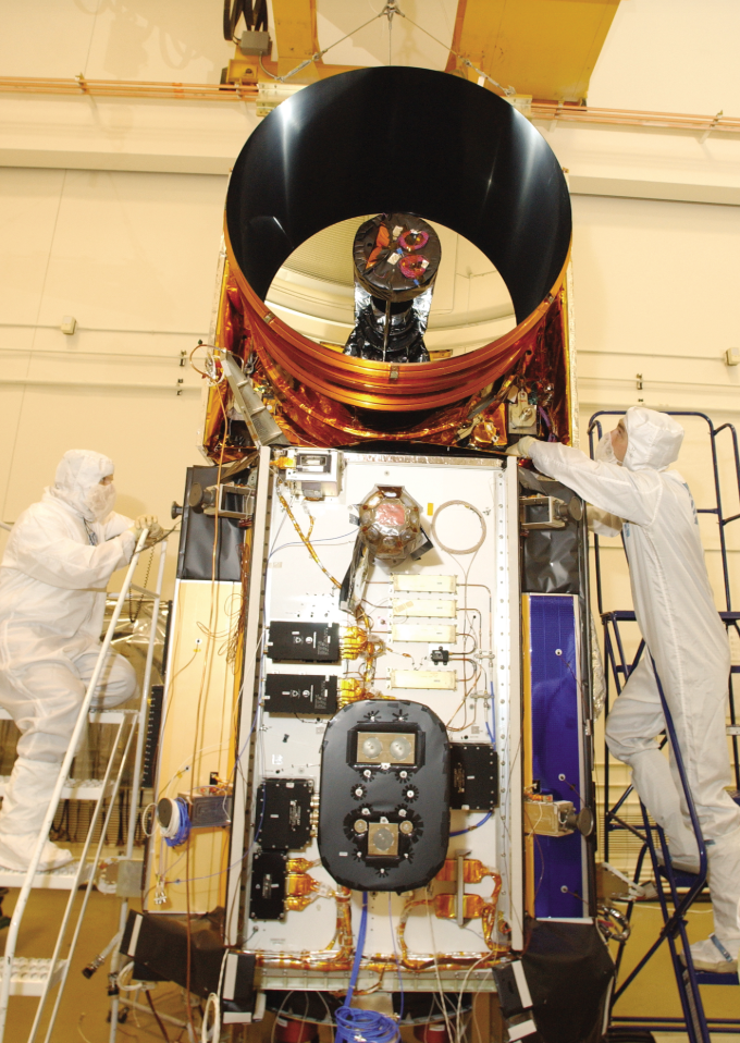 Two scientist placing things on the ICESat