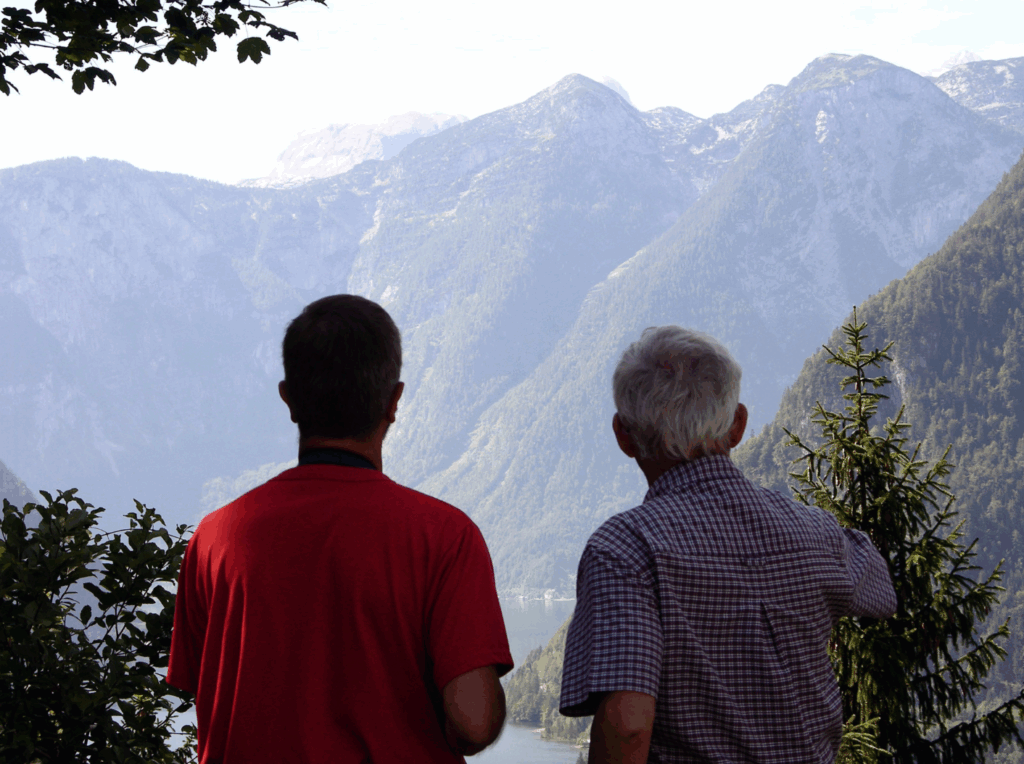 Two people looking up at mountains