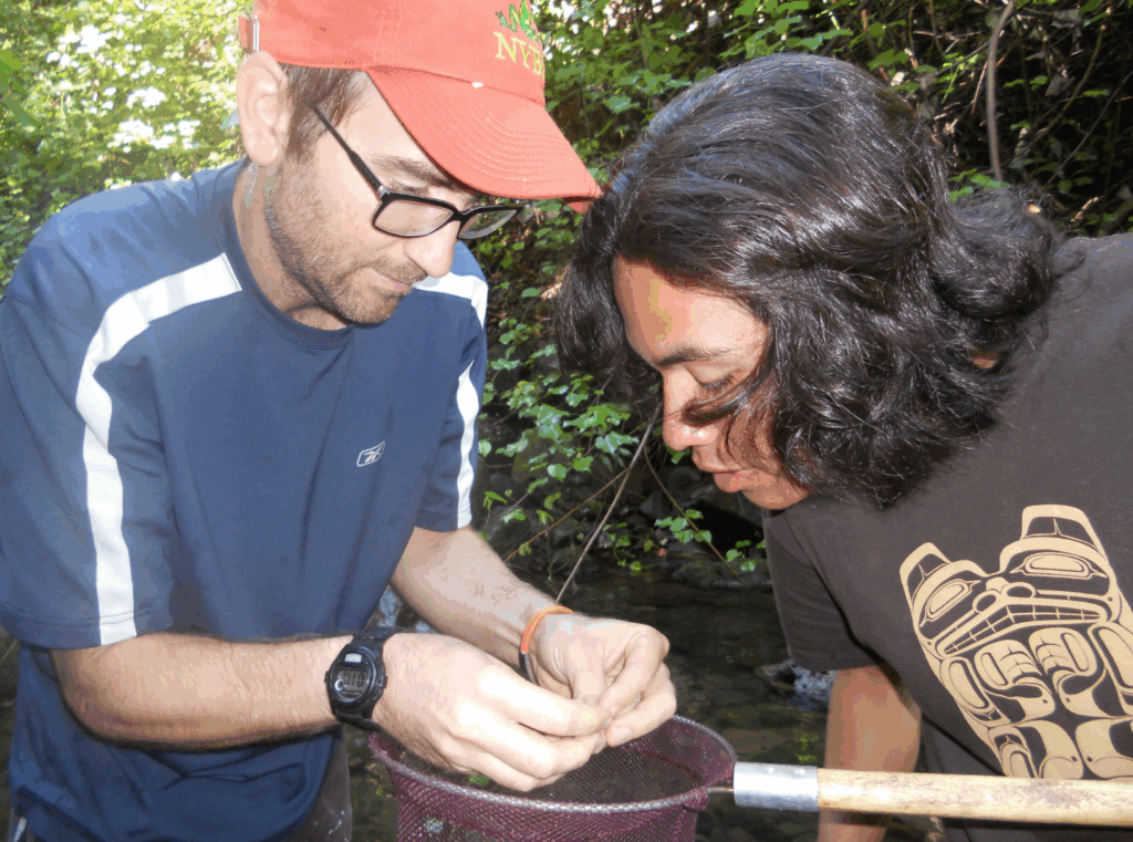 Two people observing a fish in their hands