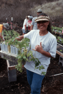 A woman with small containers of plants