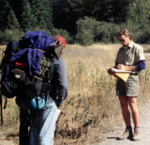 A forest manager and a backpacker at a trail head