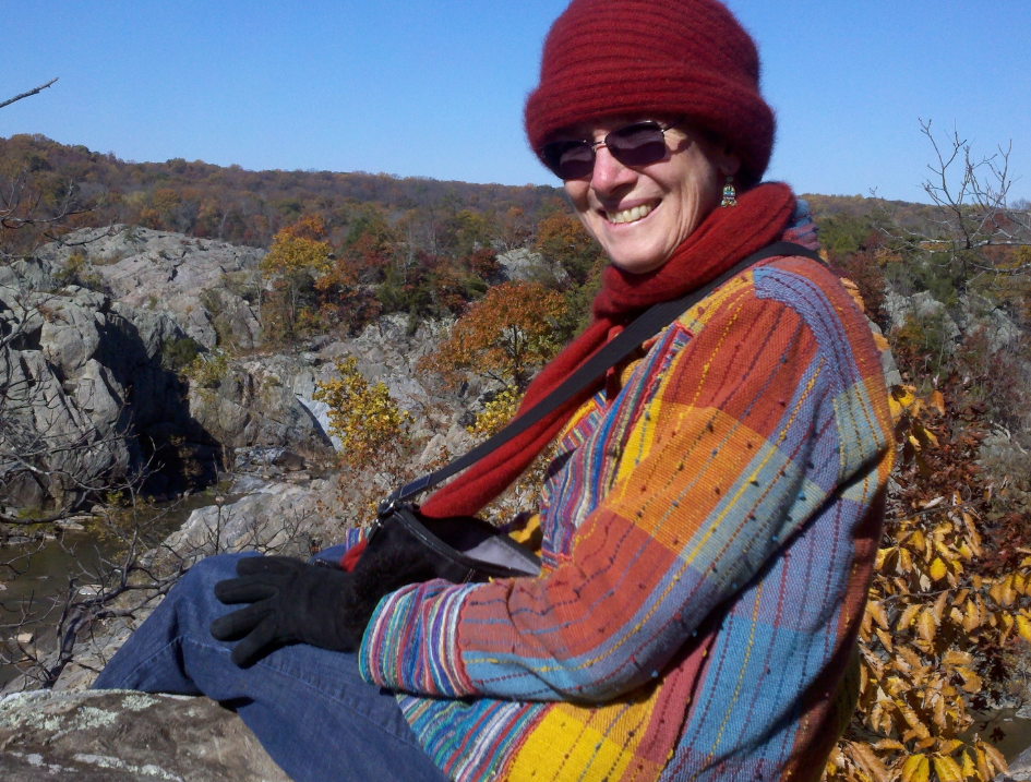 Dr. Britton sits outside in a rocky landscape
