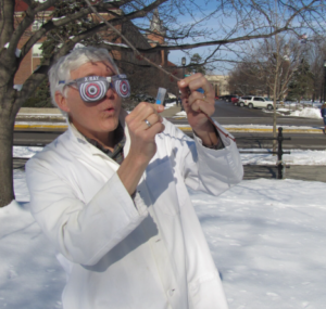 Dr. Woeste wears funny x-ray vision glasses as he appears to examine a tree in the snow.