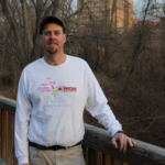 Portrait of Grove standing by a railing