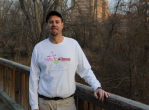 Portrait of Grove standing by a railing
