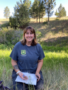 A portrait of Arian Randall holding an artifact