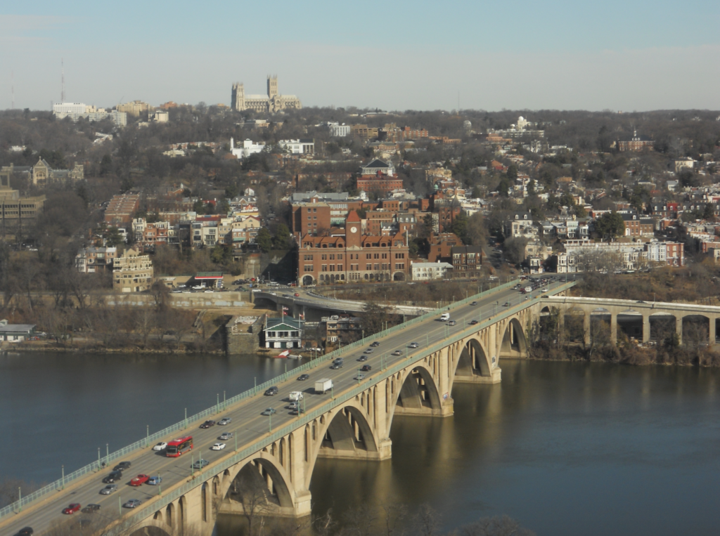 An urban area with sky skyscrapers and a bridge with many cars