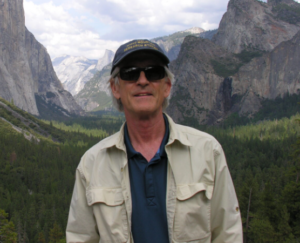 Andrzej Bytnerowicz outside with mountains behind him