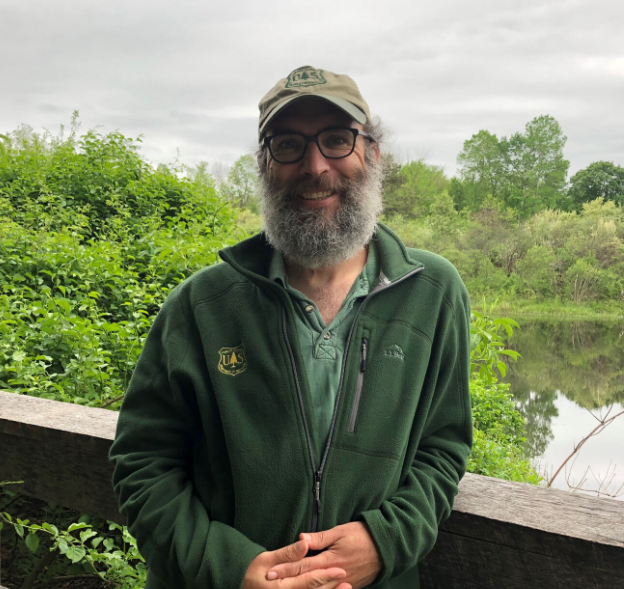 Portrait of Brett Butler outside by a bridge