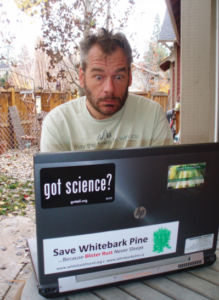 Charlie sitting at his computer outside