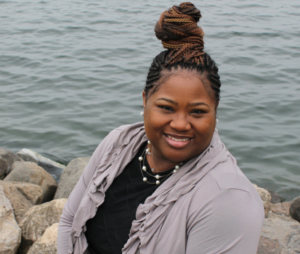 Dr. Moore sits beside a body of water