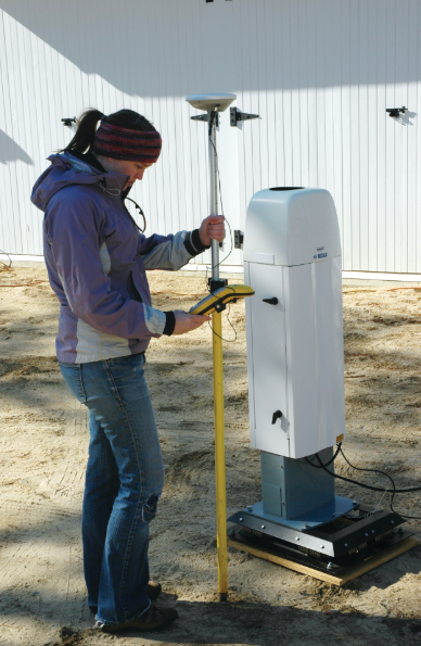 Christie Hawley using a scientific device to measure something in the ground