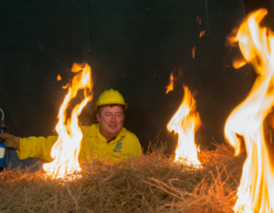 David Weise in protective gear observing a brush fire
