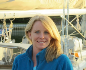 Ms. Hancock in front of a boat