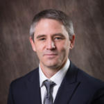 A formal headshot of Dr. Reeves