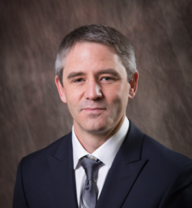 A formal headshot of Dr. Reeves