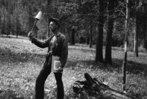Edward Kotok in a forest holding up an instrument