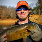 Dr. Oswalt holds up a fish.