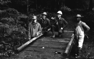 George andthree other on a bridge intheforest withhard hats on