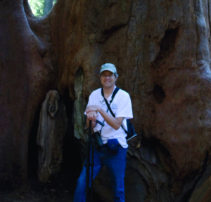 Dr. Rudie stands in front of giant sequoias