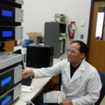 JY Zhu working on a computer in a lab