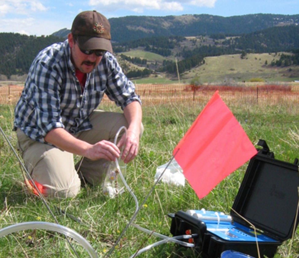 Justin Runyon working in the field with various instruments