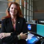 Charlie Blackwell-Thompson standing in front of her console at the Kennedy Space Center's Launch Control Center.