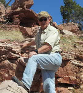 Michael Fracasso outside standing on some rocks