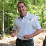 Michael Gavazzi using an instrument in a tree