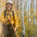 Portrait of Milena Rockwood in uniform holding a shovel in the forest