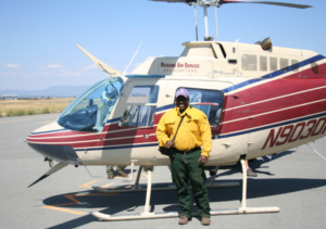 Morris Johnson standing in front of a helicopter